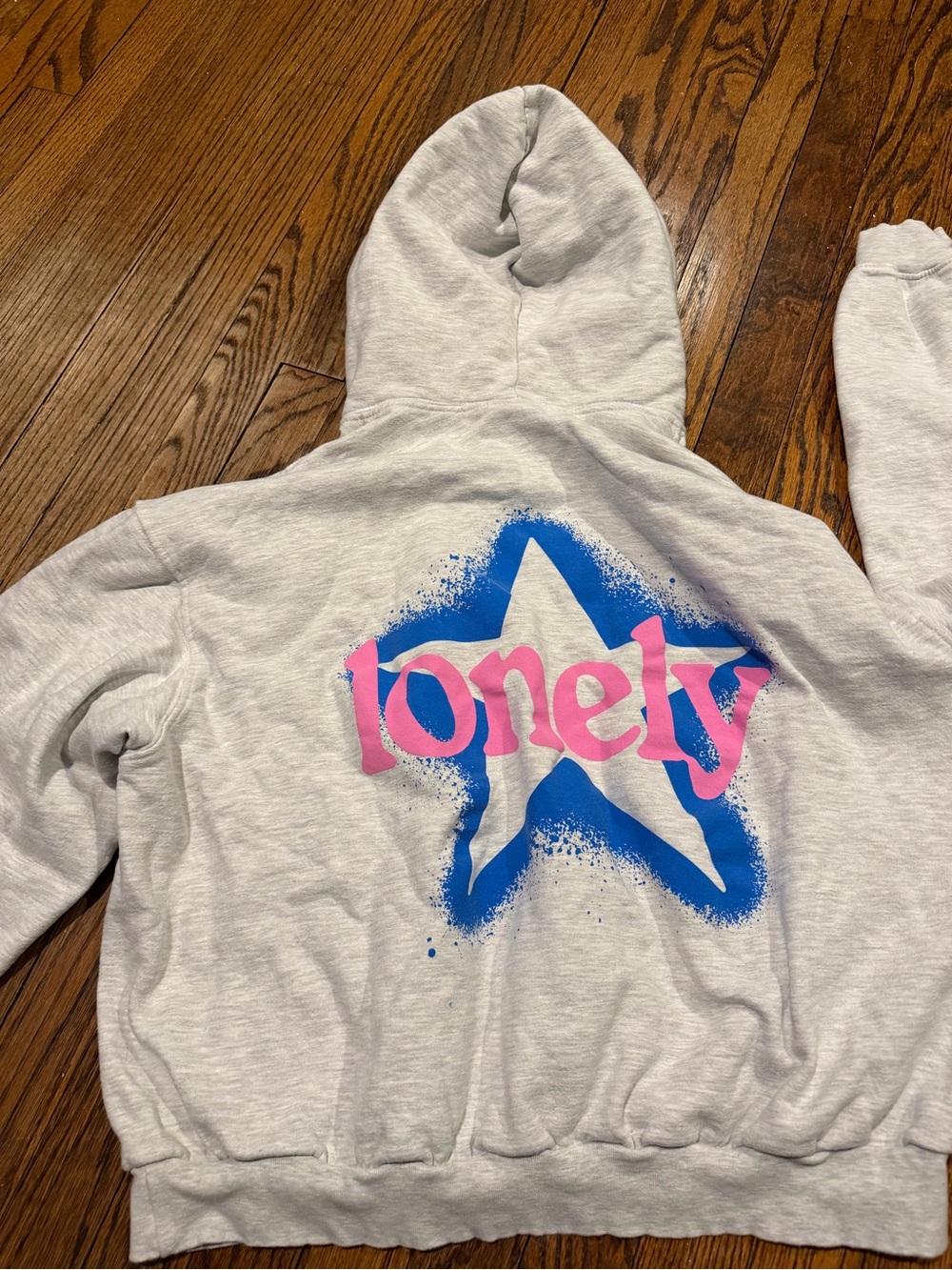 LONELY GHOST Light Gray Hoodie with Blue Star and Pink 'lonely' Graphic
